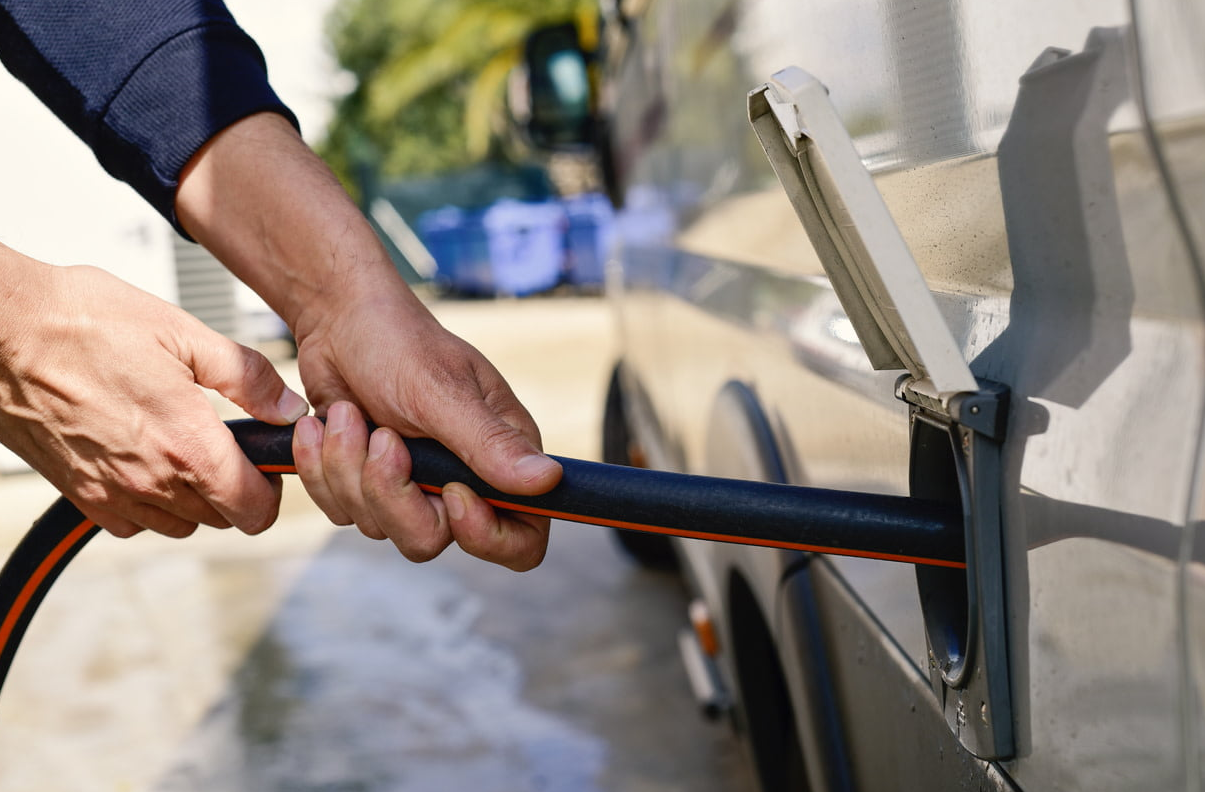 RV technician diagnosing shower issue inside an RV in Port St. Lucie